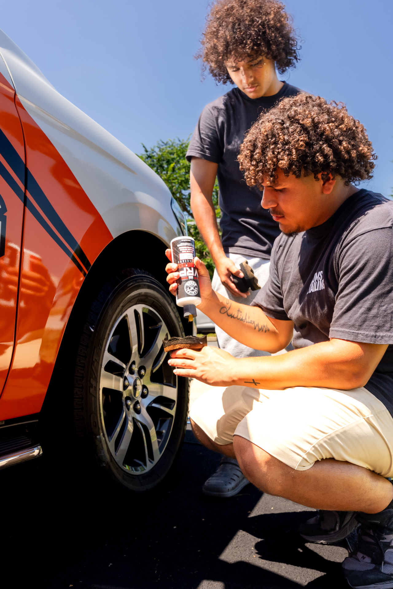 Applying dressing to a truck wheel and tire during an exterior detail in Martinsburg, WV